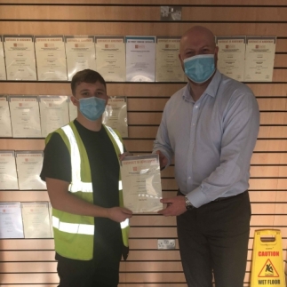 G.A. Nichols, Connor Gregory (l) with his manager Richard Walton (r) receiving his certificate for Renewables. One to add to the wall of achievements behind them