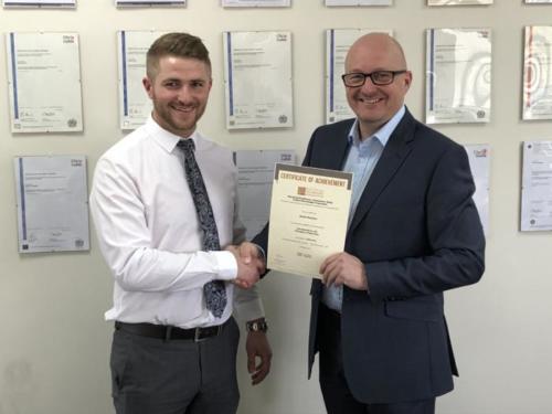 Daniel Bennion of Deta Electrical Company (l) receiving his Distinction certificate for his first EDA module Intro to the Principles of Electricity from manager Don Simler (r)