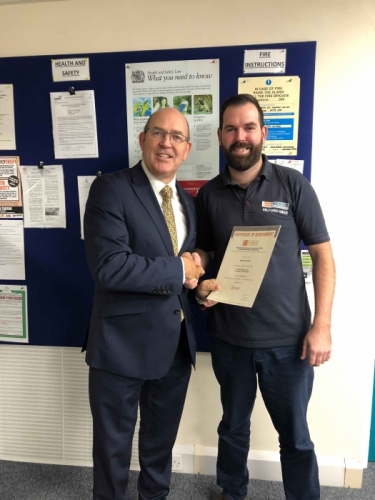Peter Brittain, Edmundson Electrical Ltd, Wales & West Regional director presenting Aaron Clayton with his certificate