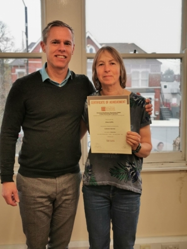 Medlocks Hilary Griffin receiving her certificate for a Distinction from her Manager, Stewart Jones. 
