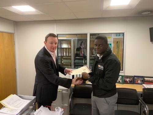 Louis Narebor-Tueje (r) of Edmundson Electrical, Blackfriars, receiving his Distinction certificate for his first module, Introduction to the Principles of Electricty, from manager Paul Conneely (l)