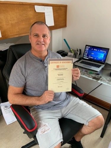 Regional Sales Manager, Rob Stewart-Brackenridge from Electrium Sales, showing that learning doesn't stop at home. Here he is with his Distinction Certificate for his first module Intro to Principles of Electricity