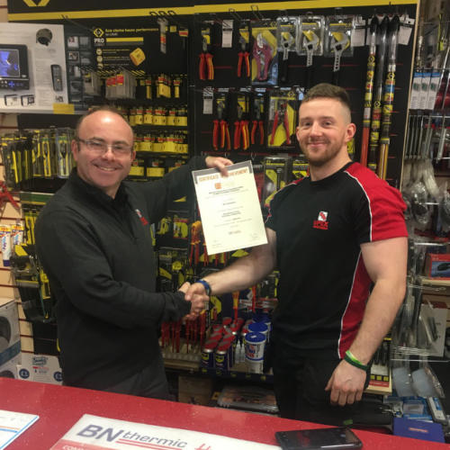 Ed Trenholme of Upex Electrical Distributors in Yorkshire, secures a Distinction in his first module - Principles of Electricity. Pictured here with manager, Dan Mooney.