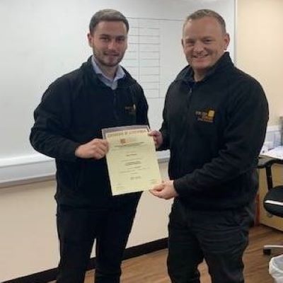 Oli Barnes (left) from Electric Center, Cheltenham receiving his product knowledge certificate from Manager, Steve Rogers
