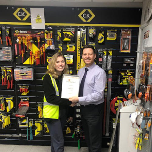 Harriet Eagle (l) Edmundson Electrical, King's Lynn, receiving her Distinction certificate from manager David Grimes (r)