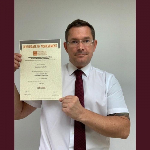 John Roberts, Area Sales Manager from Electrium Sales, with his first Distinction certificate for completing Introduction to Principles of Electricity