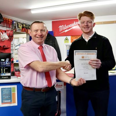 Neil Oldfield, the manager at Lockwell Electrical Ltd (Leicestershire branch) presenting Adam Thompson his first Product Knowledge Module : Customer Service. Adam has achieved a distinction. 